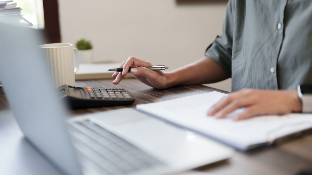 Female calculating personal financial for future plan at her home, taxes payment..